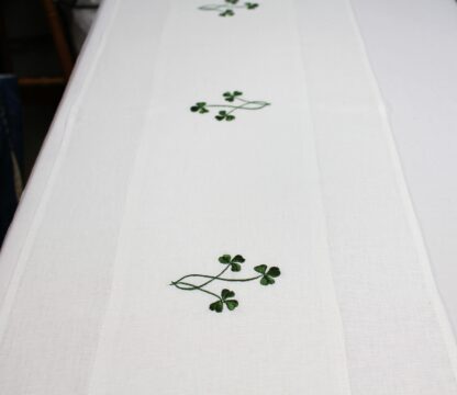 Three little Shamrocks runner in green threads on ivory Irish linen.