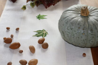 Maple leaf in green on white Irish linen.  New
