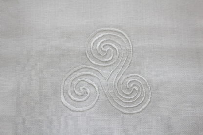 Newgrange Triple Spirals on white linen. back in stock and on Sale!!